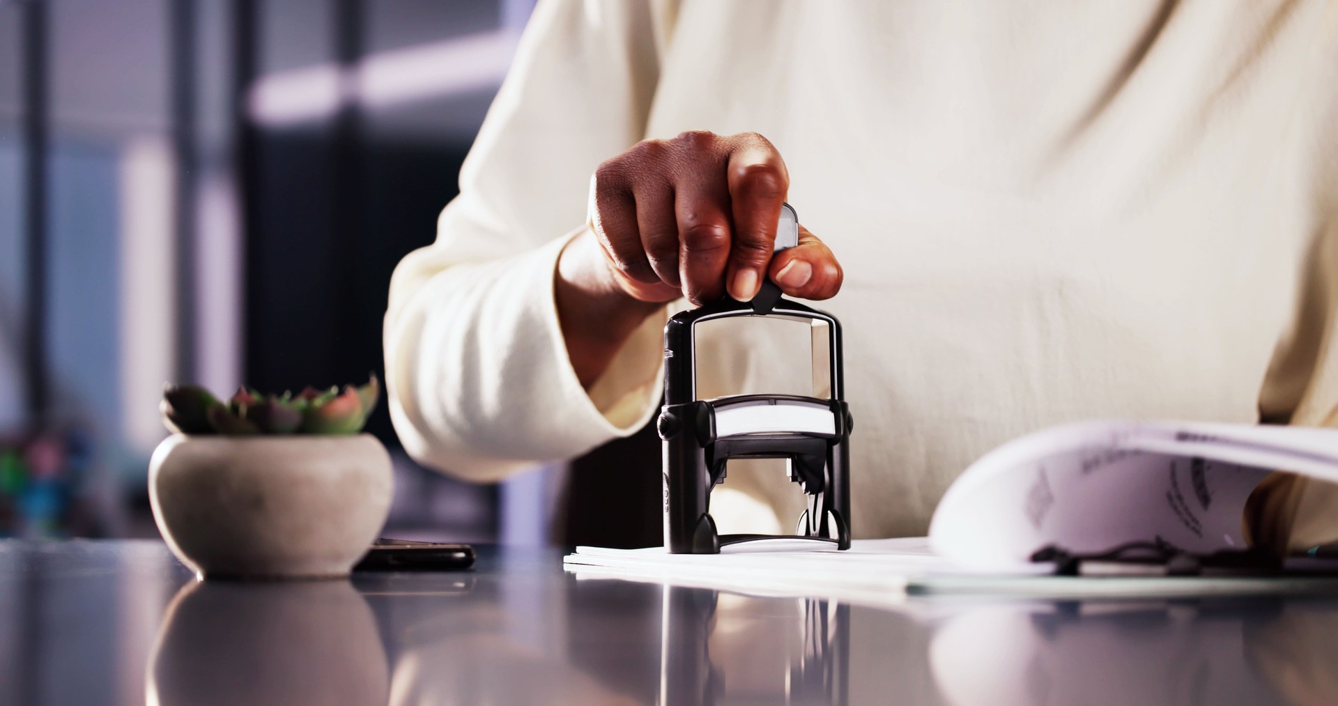 Businesswoman Notarizing Documents With Stamp In Office: Legal Assistant Approving Contracts For African American Company